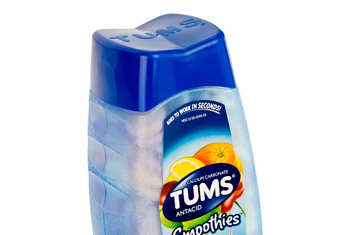 Minneapolis, Minnesota, USA - January 16, 2016: Tums Antacid Bottle.  A close-up view of a Tums Antacid bottle which is America's #1 antacid.  Tums is a registered trademark brand of GlaxoSmithKline plc.