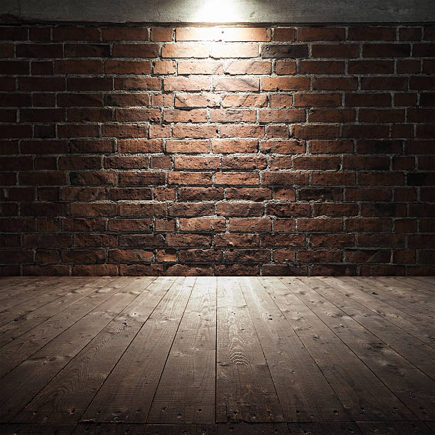 istock Wooden floor and red brick wall with spot light 507499142