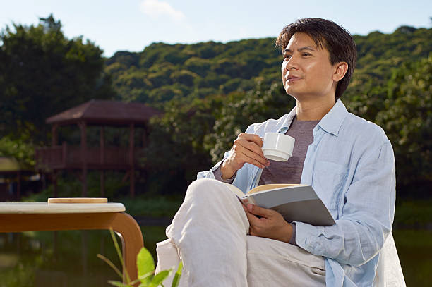 istock man reading outdoor with coffee in hand 507501102