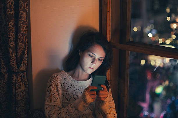 istock Sad woman texting at home 507501252