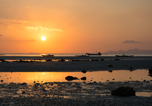 SUNSET SCENIC SEASIDE LANDSCAPE AT ROCK BEACH , EVENING TIME SUNSET SKYLIGHT BACKGROUND