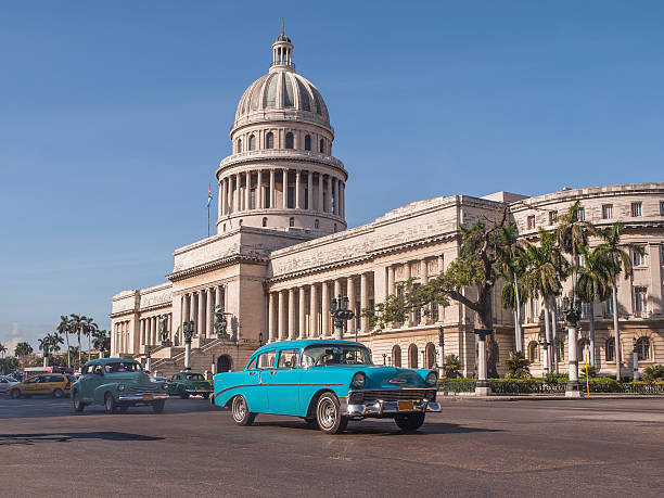 Classic cars in front of the Capitol in Havana. Cuba old American cars passing in front of the Capitolio in Havana, Cuba havana photos stock pictures, royalty-free photos & images