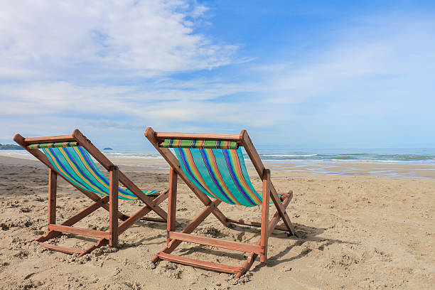 istock Canvas chair on beach and blue sky 507513927