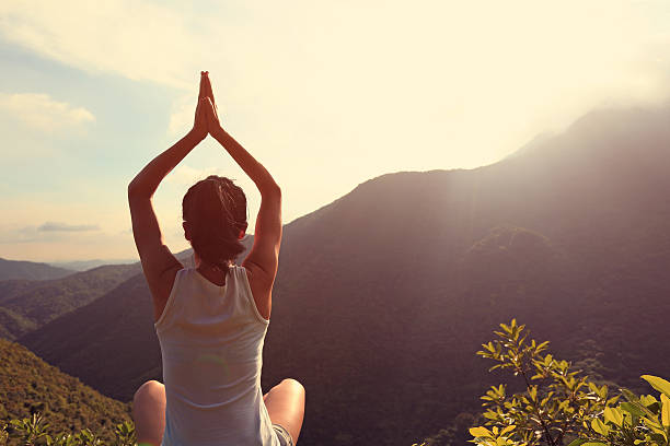istock yoga woman practice on mountain peak 507514408