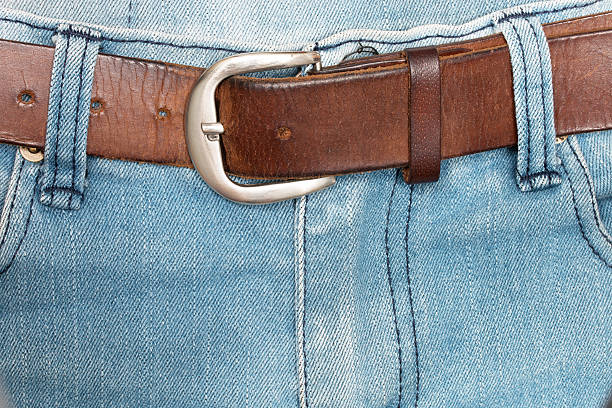 istock Old brown belt with blue jeans. 507515036