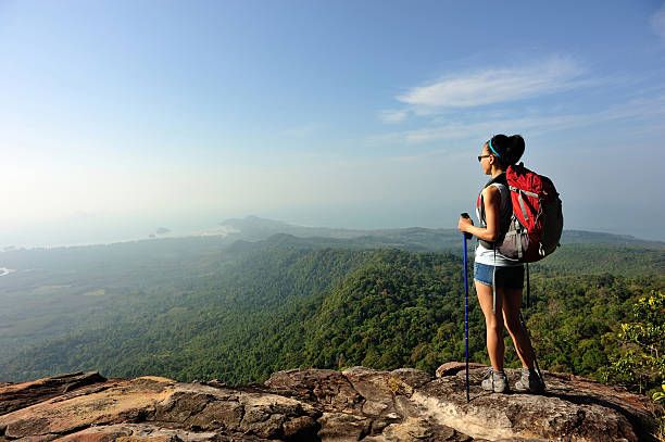 istock woman hiker enjoy the view at mountain peak cliff 507515500