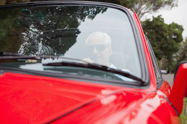 istock Handsome man driving red convertible 507515843