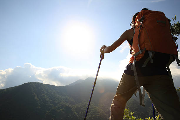 istock young woman backpacker climbing to mountain peak 507516450