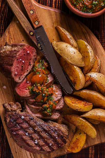 istock Grilled steak with potato wedges, salsa and spices. 507517286