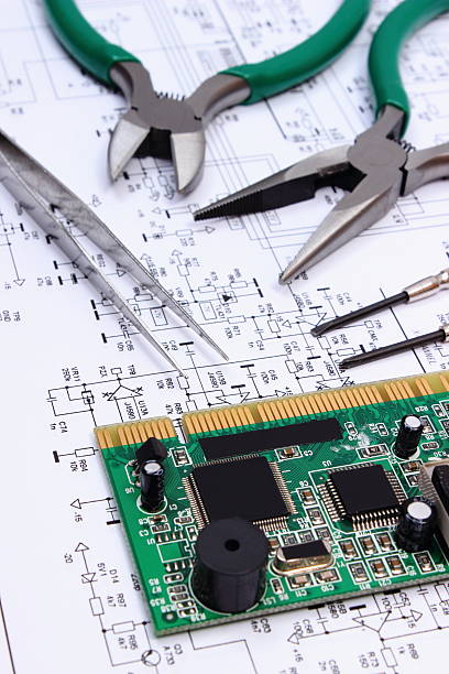 istock Printed circuit board and precision tools on diagram of electronics 507517382