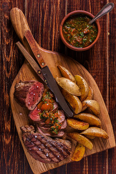 istock Grilled steak with potato wedges, salsa and spices. 507517406