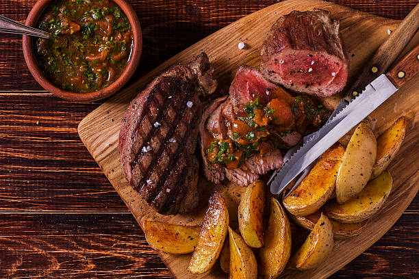 istock Grilled steak with potato wedges, salsa and spices. 507517548