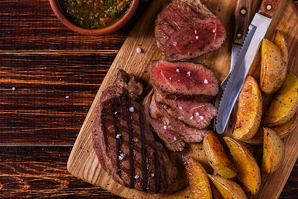 istock Grilled steak with potato wedges, salsa and spices. 507517656