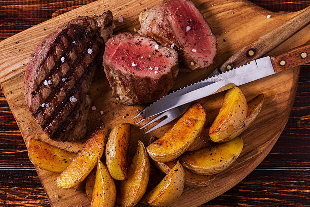 istock Grilled steak with potato wedges, salsa and spices. 507526554