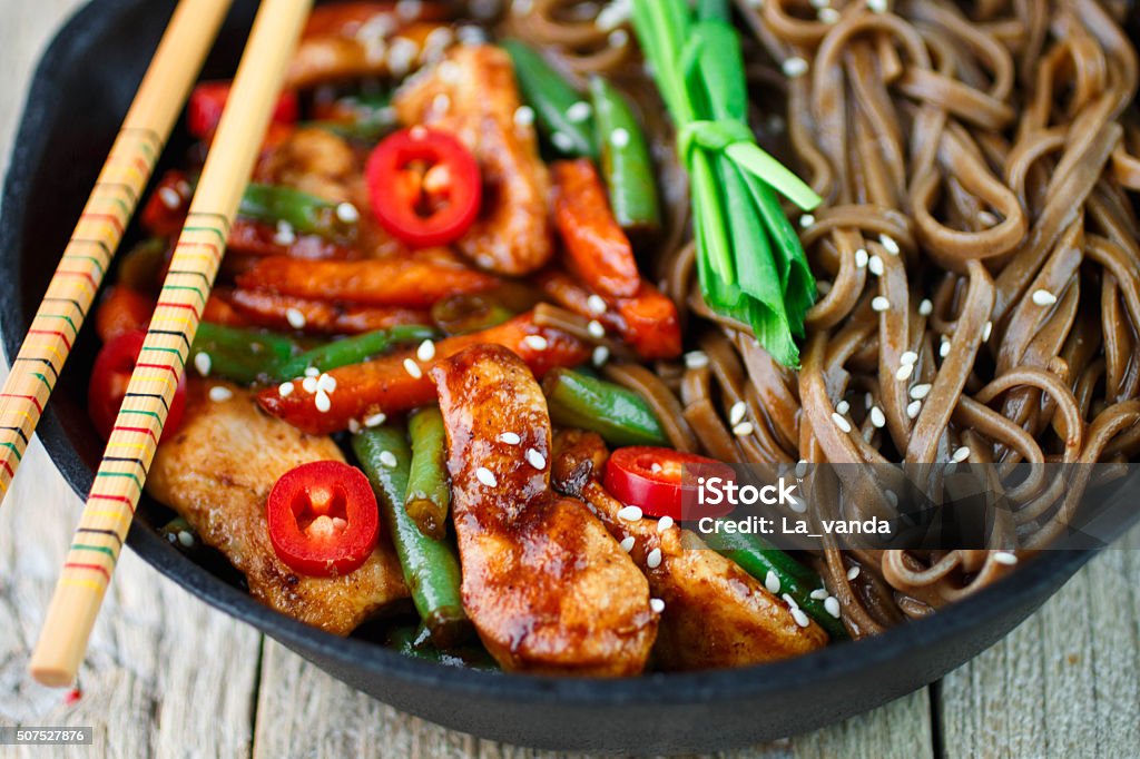 Soba macarrão de trigo sarraceno com frango, vagem, cenouras, cebolinha - Foto de stock de Alho royalty-free