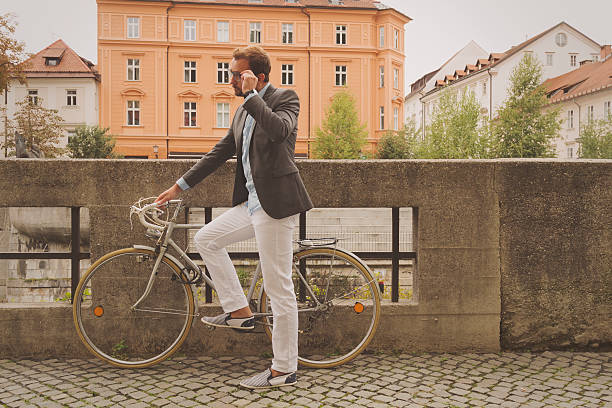 Hipster guy with bicycle outdoors.