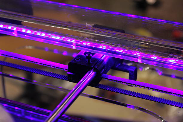 3D printer pulleys and guiding rod detail Macro of violet-lit 3D printer pulleys and guiding rod detail polylactic acid stock pictures, royalty-free photos & images