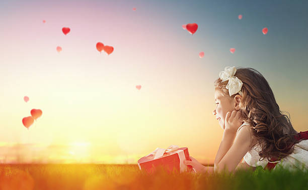 istock girl looking at red balloons 507532932