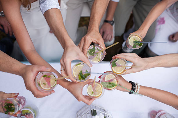 people celebrate. Clink glasses with the drink stock photo