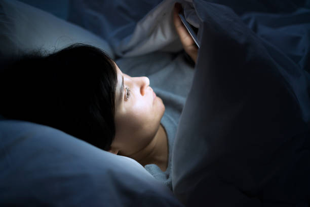 istock Woman using phone in bed 507535088