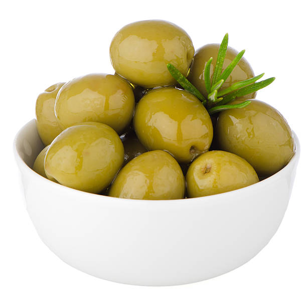 istock Green olives in a white ceramic bowl 507540619
