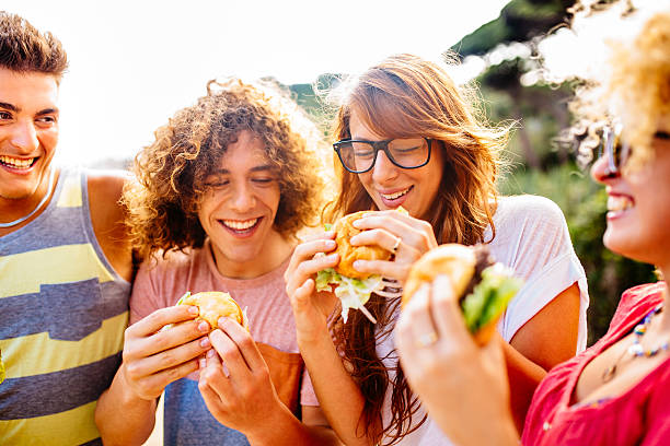 istock Friends Eating Burgers 507540765