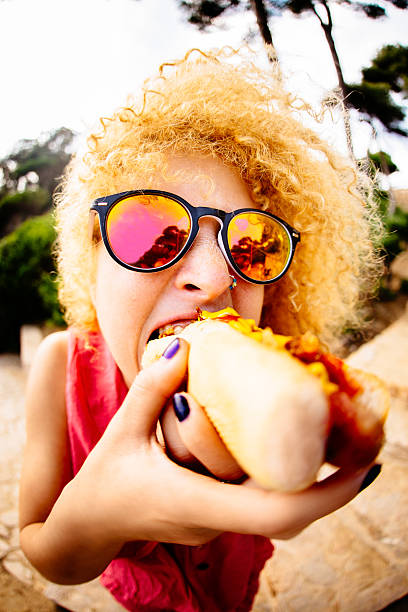 Asian young man eating burger.
