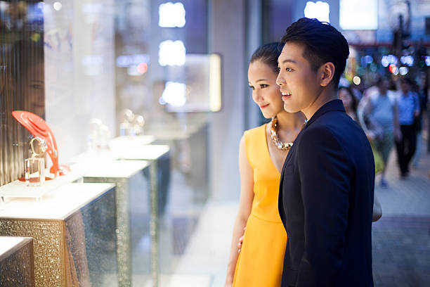 Shopping jewelry Young couple looking at jewelry in Hong-Kong shopping asia stock pictures, royalty-free photos & images