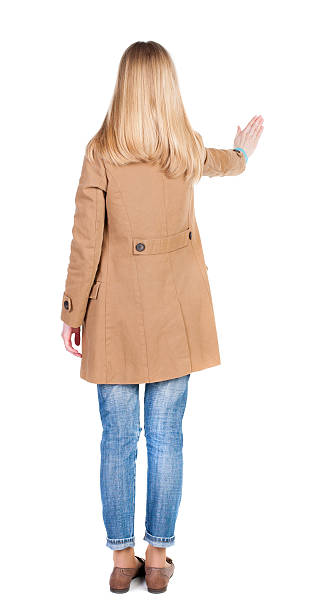 istock Young woman in cloak presses down on something. 507545238