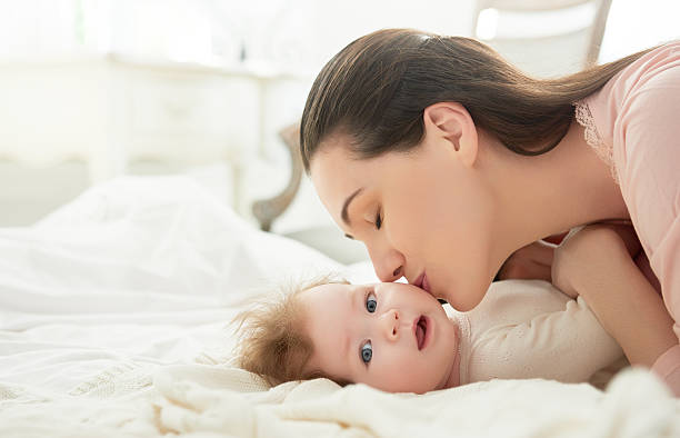 istock mother playing with her baby 507546054