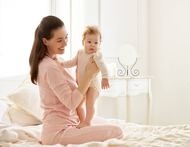 istock mother playing with her baby 507546080
