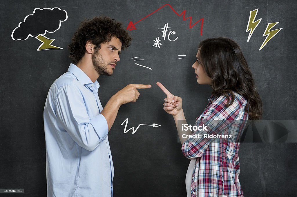 Couple Having Argument Discussion Between Guy And Girl Over Gray Background Couple - Relationship Stock Photo