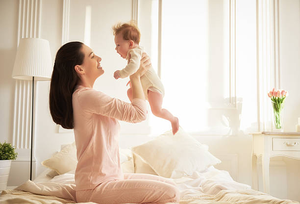 istock mother playing with her baby 507546398