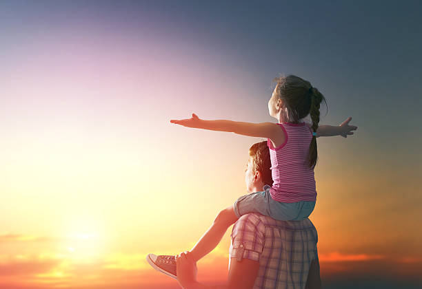 istock happy family at sunset. 507547648