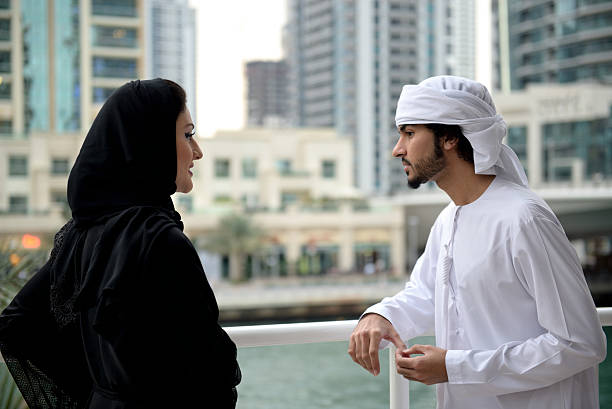istock Young Emirati couple standing and talking 507550398