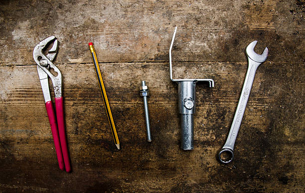 istock Tools and parts on old wooden table 507550554