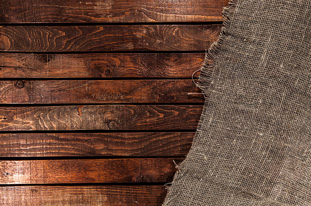 istock Burlap texture on wooden table background 507550674