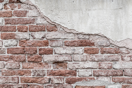 Cracked and textured pink wall, plaster background