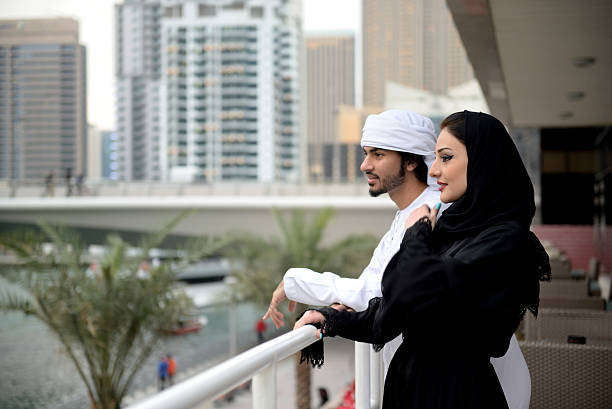 Young Emirati couple standing and talking