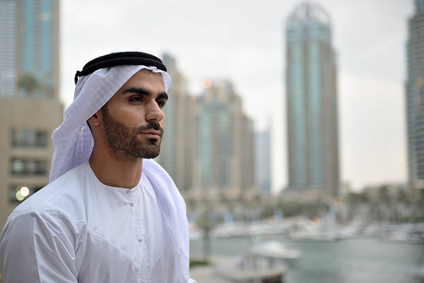 istock Young Emirati man standing by the canal in Dubai 507551480