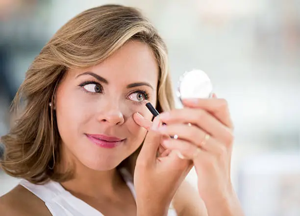 Photo of Woman applying eyeliner - makeup concepts