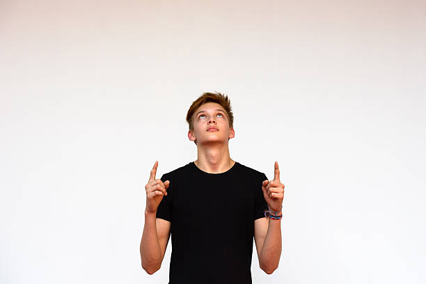 istock Teenager boy outdoors pointing and looking up 507553114