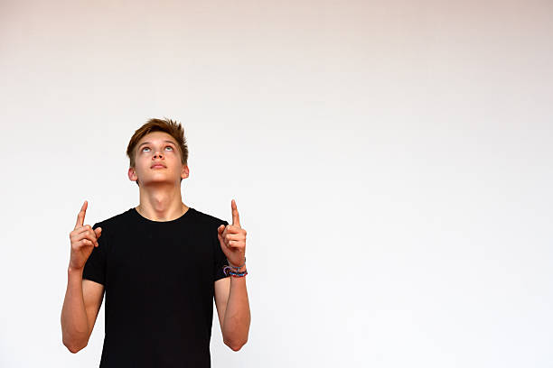 istock Teenager boy outdoors pointing and looking up 507553148