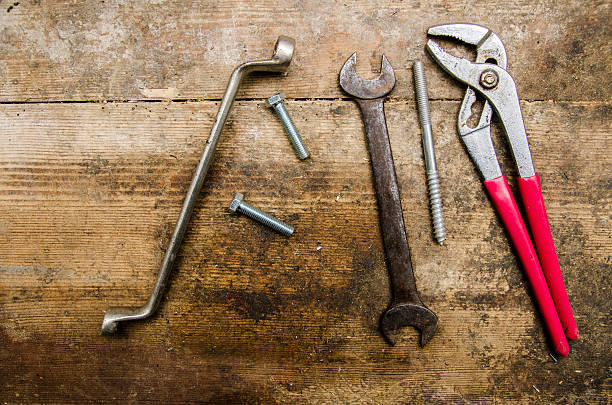 istock Tools and parts on old wooden table 507553180
