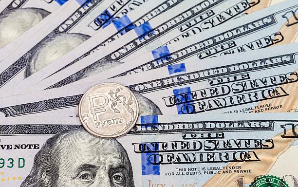 istock Russian rubles coins over dollars banknotes 507565818