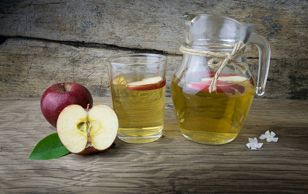 istock Apple juice and apples on a wooden table 507566648