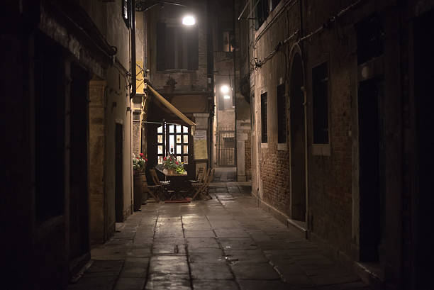 Cozy restaurant in an alley at night in Venice Cozy restaurant in an alley at night in Venice, Italy alley stock pictures, royalty-free photos & images