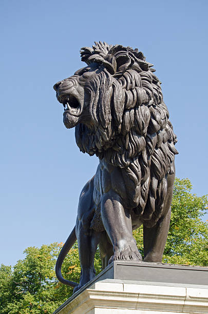 The magnificent lion sculpture topping the Maiwand war memorial on public display in Forbury Gardens, Reading, Berkshire.  It commemorates those killed in the Battle of Maiwand during the Second Anglo-Afghan war in the late 19th century.  Sculpted by George Blackall Simonds and made of cast iron.