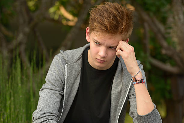 istock Sad teenager boy outdoors alone 507569162