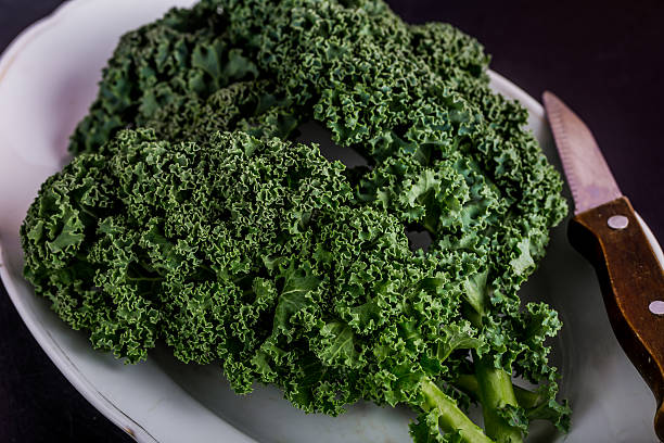 istock Fresh green kale on white plate 507569248
